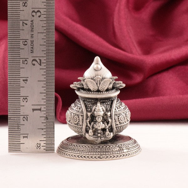 925 Silver Lakshmi Kalasam idol, 5.5cm tall, weighing 61g, with detailed engravings and red fabric backdrop.