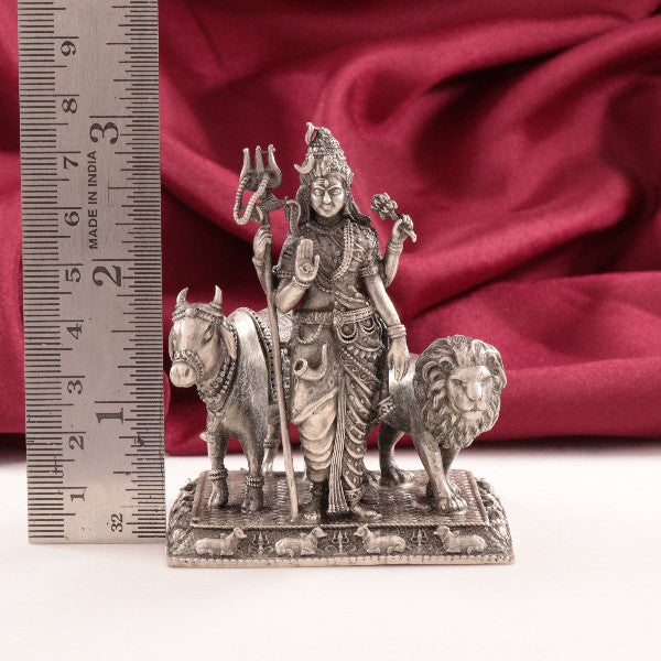 925 silver 3D Arthanatheswarar idol weighing 123g, 7.5cms in length, shown next to a ruler against a red fabric background.