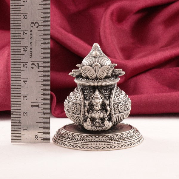925 silver 2D Lakshmi Kalasam idol weighing 94g with 6.5cm height, detailed design, and purity 925, placed near a ruler for scale.