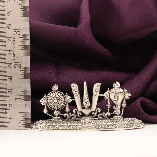 925 silver Shanku Chakra Namam idol, 49g, 4cms length, purity 925, next to a measuring scale on purple fabric.