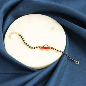 925 silver kids bracelet with red car charm on a blue fabric background