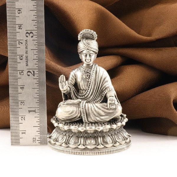 925 silver 3D Swami Narayan idol, 114g, 8cm length, purity 925 silver, detailed craftsmanship with brown fabric background and ruler scale.