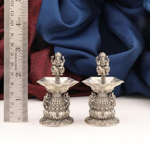 Intricate 925 silver 2D Ganesha Deepam AD-35, pair of 109g lamps with detailed designs, shown with a ruler for scale.