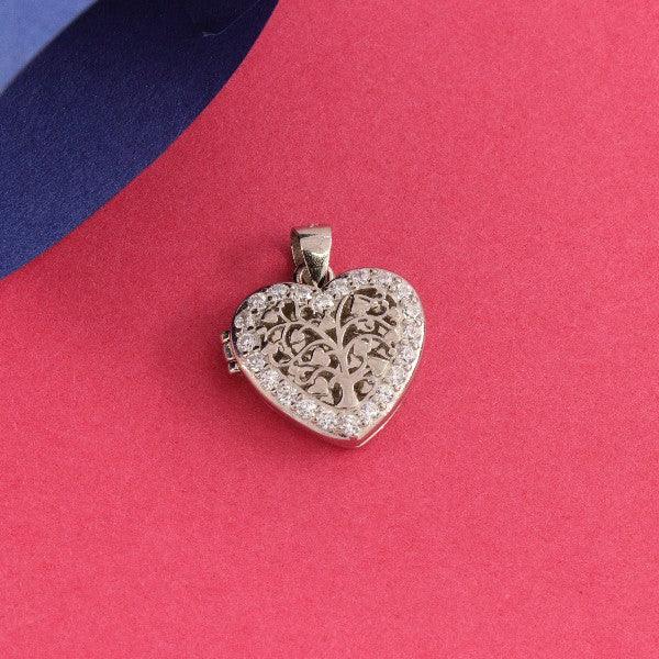 925 silver heart-shaped pendant for women with intricate design resting on a red surface.