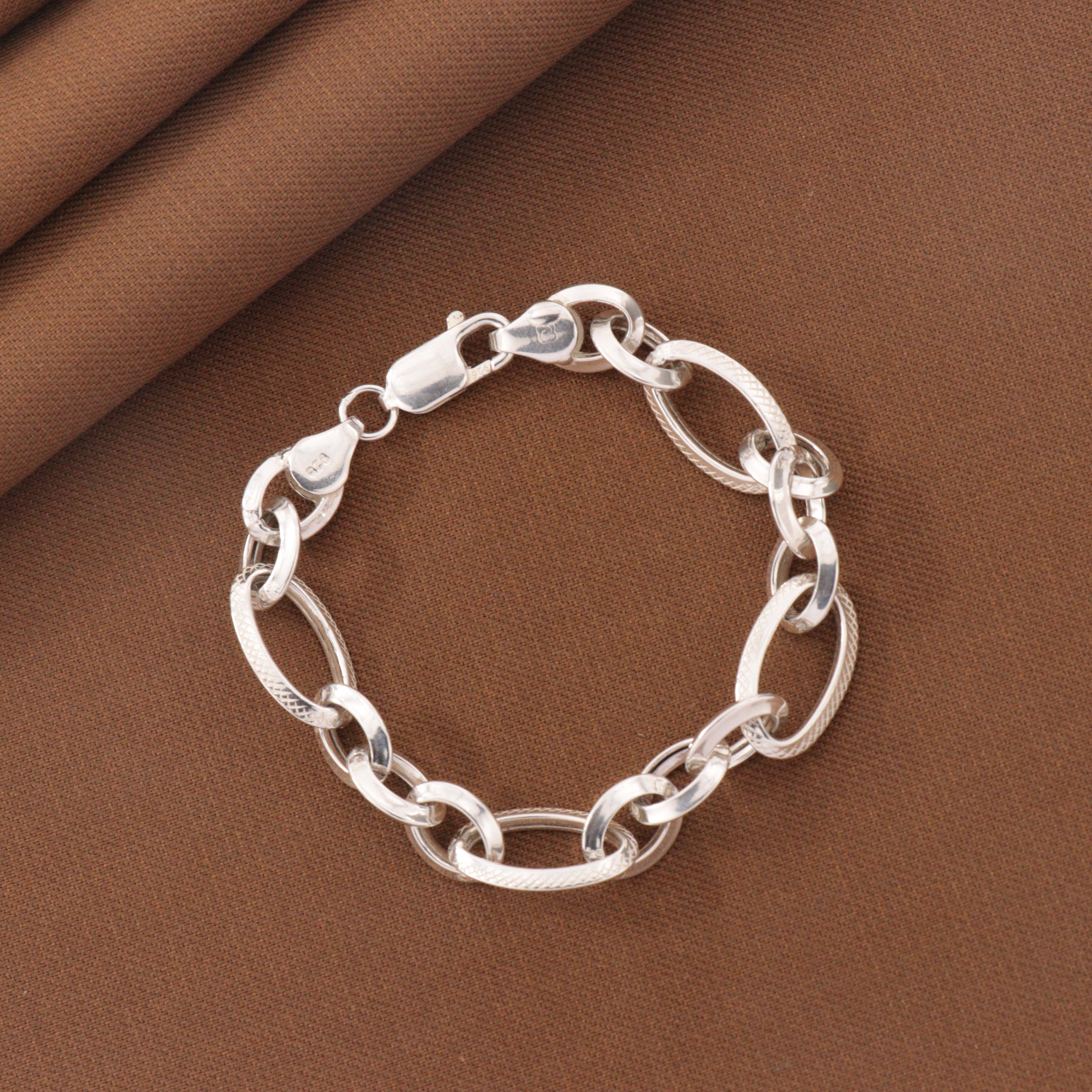 925 Silver Hemlata Kids Bracelet KB-204, chain design, 16cm length, 6g, elegant child jewelry on brown fabric background.