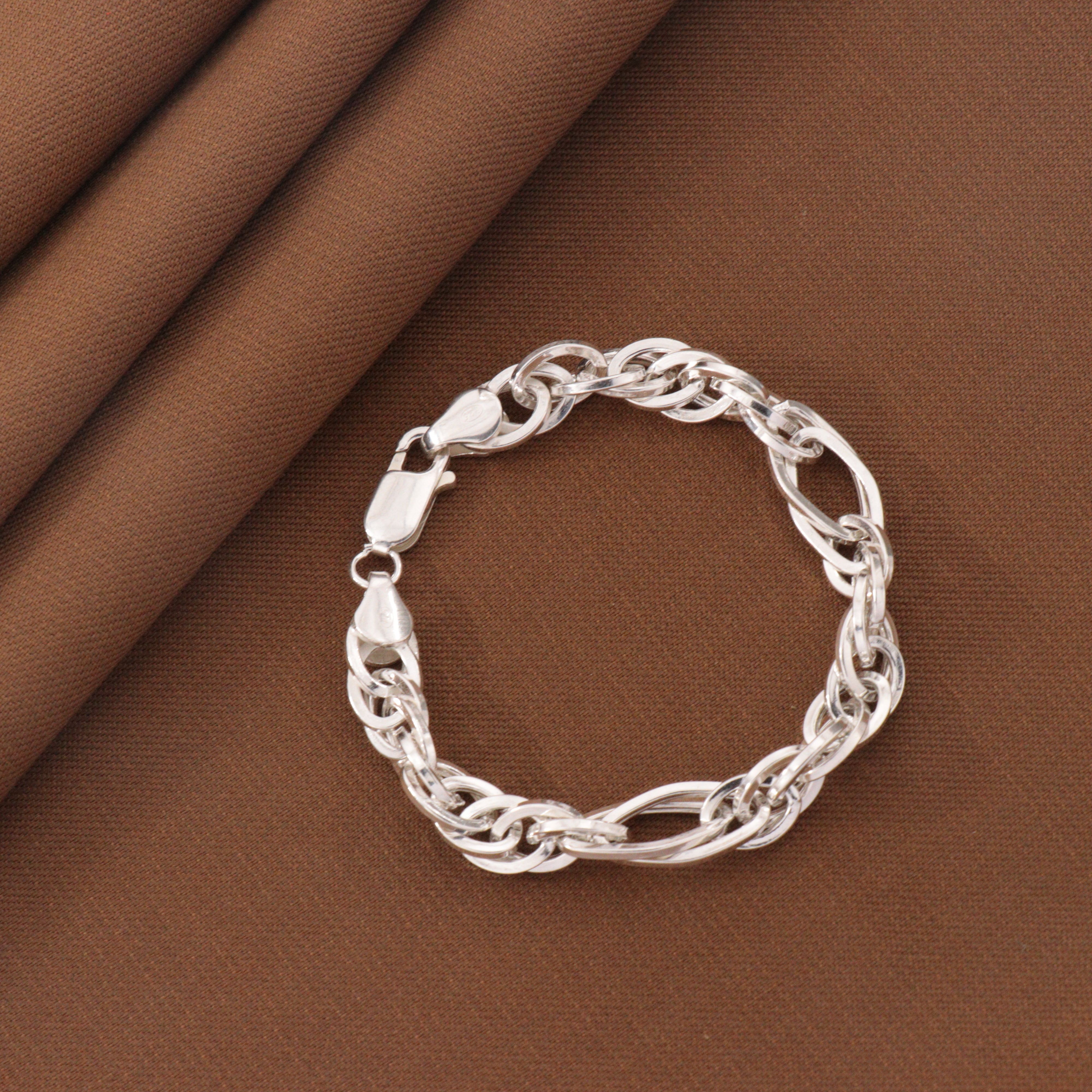 925 Silver Supriya Kids Bracelet KB-203 on brown fabric, 15cms length, 6g weight, showcasing elegant chain design.