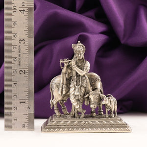 925 Silver 3D Krishna Idol, 116g, 8cms, AI-1200, next to a ruler for size comparison, purple fabric background