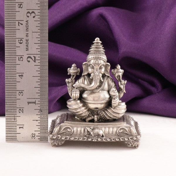 925 silver 3D Ganesha idol measuring 6 cm in length, weighing 89g, displayed next to a ruler for scale, with a purple cloth background.