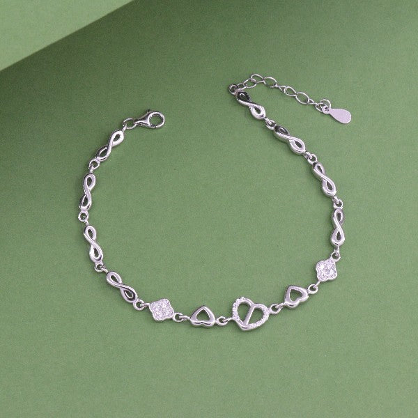 925 Silver Nirmayi Women Bracelet LBR-378, 7g, 21.5cms, featuring heart and square charms on a green background.