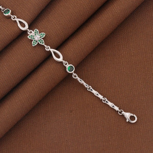 925 silver kids bracelet with floral design on a brown fabric background, showcasing its elegant and intricate details.