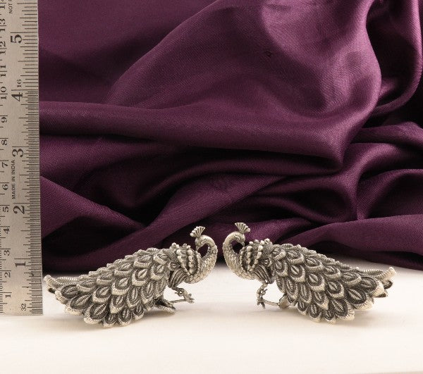 925 Silver 3D Peacock Articles Idols AI-1234, Weight 104g, Length 3cms, Showcased on Purple Fabric with Ruler for Scale