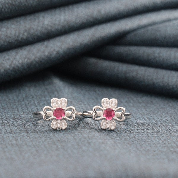 Elegant 925 silver Mithi women toe-rings TE-283 with pink gemstone, 4g weight, showcasing intricate design on fabric background.