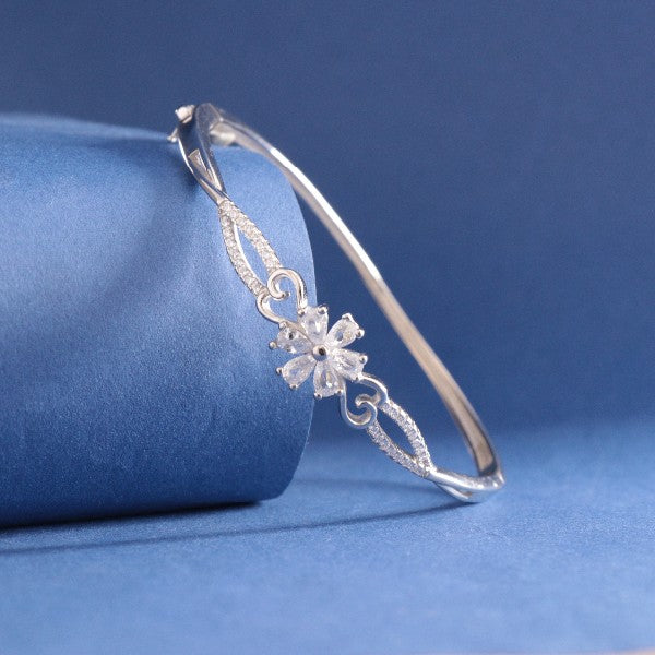 Elegant 925 silver Tarjani women Kada bracelet with intricate flower design, displayed on blue background