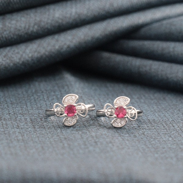 925 silver Anurati women's toe-rings with pink stones on cloth background, weight 4g, designed in intricate floral pattern.