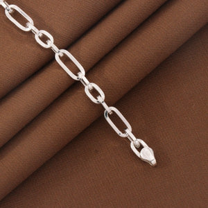 925 Silver Ravindra Kids Bracelet KB-202 with sturdy links on brown fabric, 15cm long and 5g, showcasing quality and style.