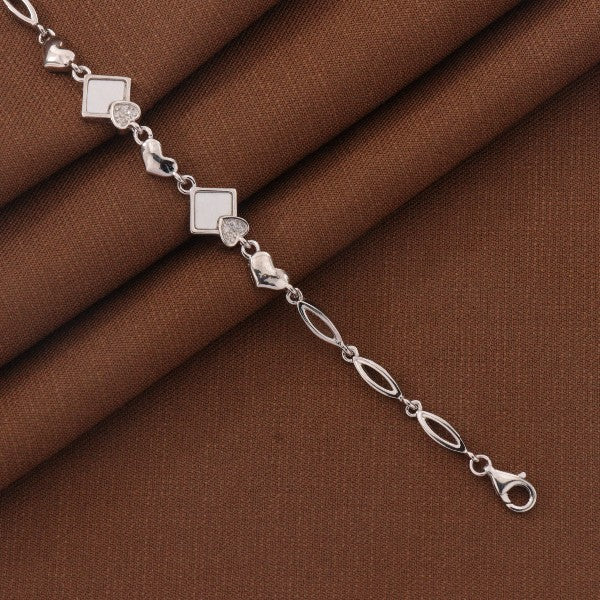 Elegant 925 silver kids bracelet with geometric design, 18cm length, shown on a brown fabric background.