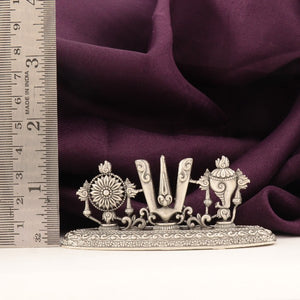 925 silver Shanku Chakra Namam idol, 49g, 4cms length, purity 925, next to a measuring scale on purple fabric.