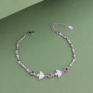 925 silver Urja women's bracelet with red gemstones, 21cm length, 7g weight, and purity 925, on a green background