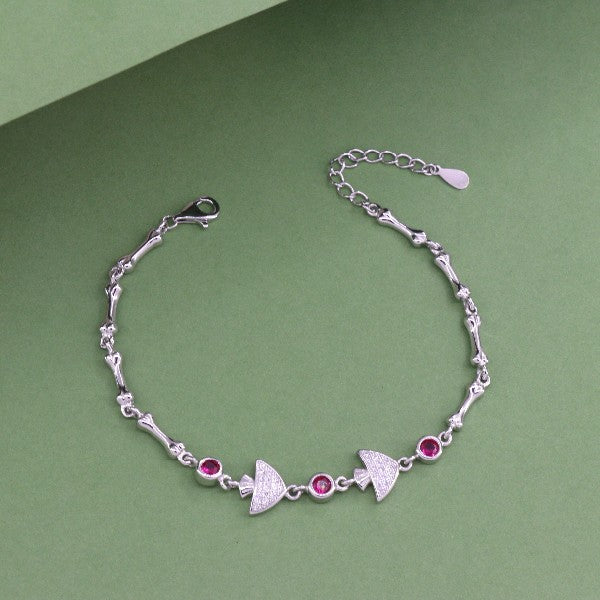 925 silver Urja women's bracelet with red gemstones, 21cm length, 7g weight, and purity 925, on a green background