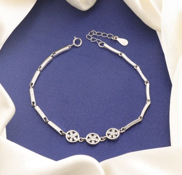 925 Silver Anulekha Women Bracelet LBR-388 with three floral design accents, 20cm length, 4g weight, on navy blue and white fabric background