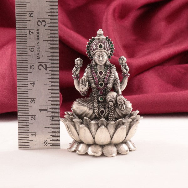 925 silver 3D Mahalakshmi idol weighing 94g and measuring 7cms in height displayed with a ruler for scale against a red fabric background.