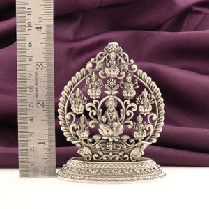 925 silver 2D Ashtalakshmi idol with intricate detailing, 9cm in height, placed next to a ruler on purple fabric