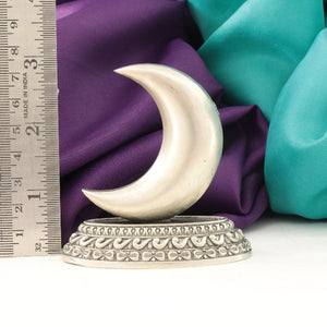 925 silver moon idol with intricate design, measuring 7.5cm in length, placed beside a ruler with a purple and turquoise fabric background