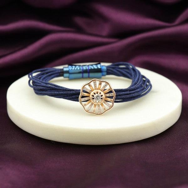 Elegant navy blue bracelet with flower charm on stand background