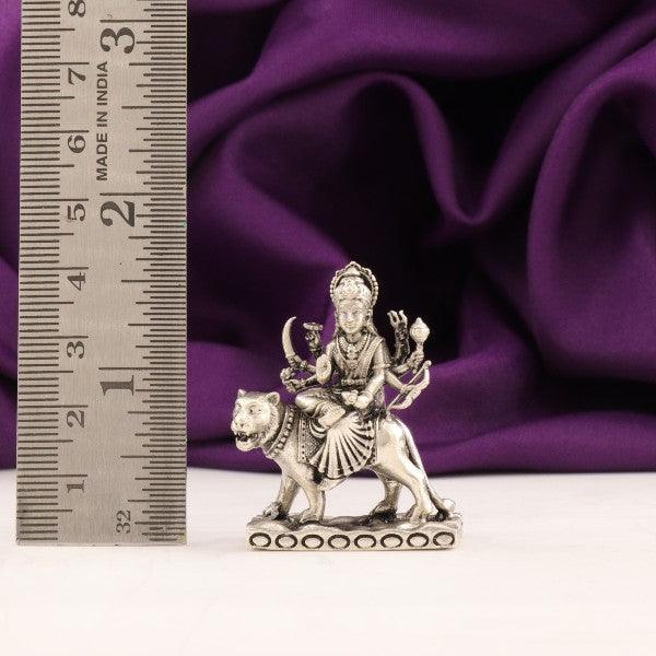 925 silver 3D Durga Devi idol with lion, 36g, 4cms dimension, purity 925 silver, next to a measuring ruler on a purple background