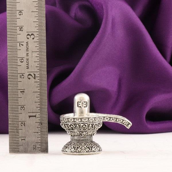 925 silver 3D Shivling idol with intricate design, 3cm high, weighing 40g, displayed next to ruler for scale on purple cloth