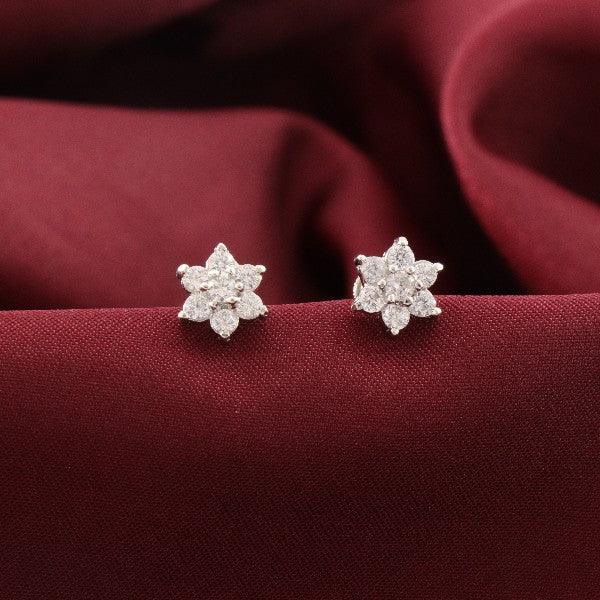 925 silver Gatita Kids Studs KS-127 with a star-shaped design on a burgundy fabric, showcasing purity and elegance.