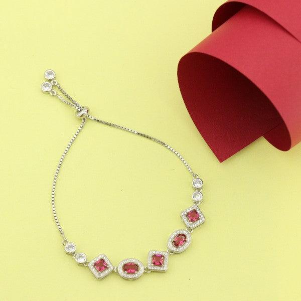 925 silver Pankaja women bracelet LBR-222 with red gemstones on a yellow background next to red packaging. Purity 925, adjustable size.