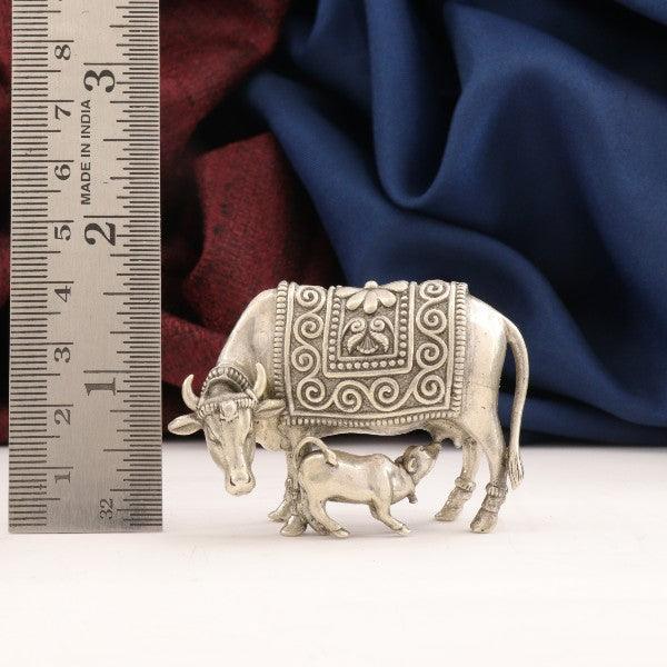 925 silver 3D Kamadenu idol weighing 73g and measuring 4cms in length placed next to a ruler for size reference