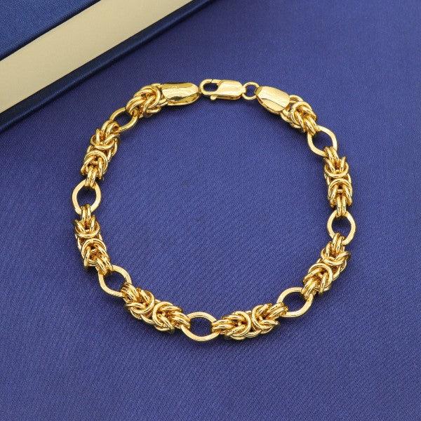 Gold braided bracelet with intricate design on a blue background