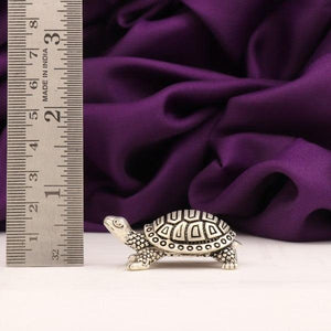 925 silver 3D tortoise idol, 33g, 1.5cm length, with ruler for scale and purple fabric background.