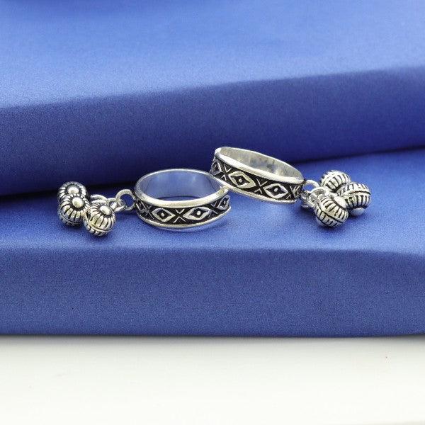 925 silver Manjusri women toe rings TE-147 with intricate design and hanging charms on blue fabric background