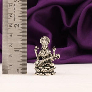 925 silver Saraswathi idol, 33g, 4cm, near ruler on purple background