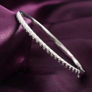 Elegant 925 silver Sachi Women Kada WKD-136 bangle on purple fabric background