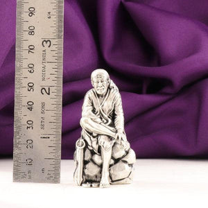 925 silver 3D Sai Baba idol weighing 46g with dimensions of 6cms beside a ruler showing scale