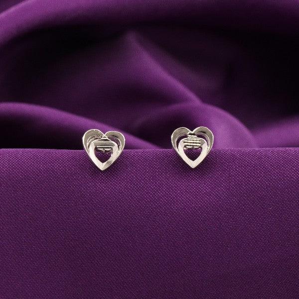 925 silver Paridhi kids heart-shaped studs KS-136 on a purple fabric background