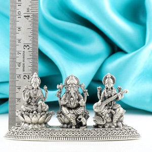 925 silver idols of Lakshmi, Ganesha, Saraswathi with ruler for scale, 108g, 5.5cm length, purity 925