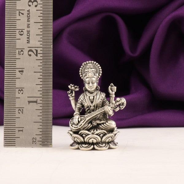 925 silver 3D Saraswathi idol, 53g and 4.5cm in length, with a ruler beside for size reference, against a purple fabric background.