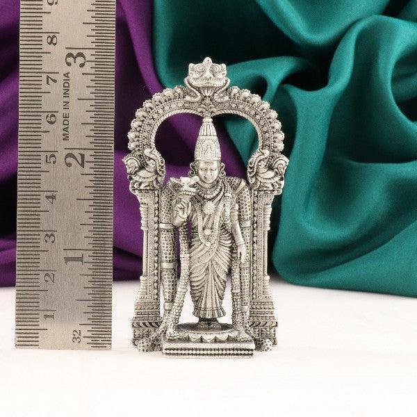 925 silver 2D Meenakshi Amman idol, 7.5cm in height, weighing 43g, standing next to a measuring scale with a colorful fabric background.