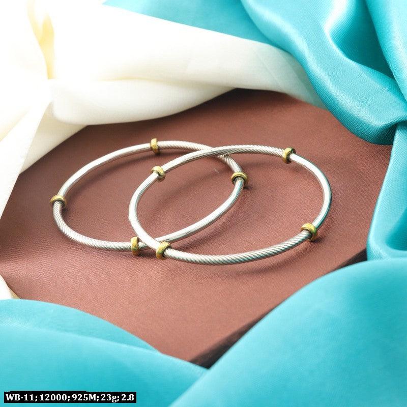 Pair of 925 silver bangles WB-11 for women, 23g, 2.8-inch diameter, displayed on a colorful fabric background.