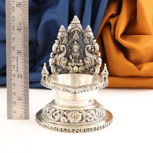 Exquisite 925 silver 2D Lakshmi deepam weighing 157g with intricate detailing, shown with ruler for dimensions.