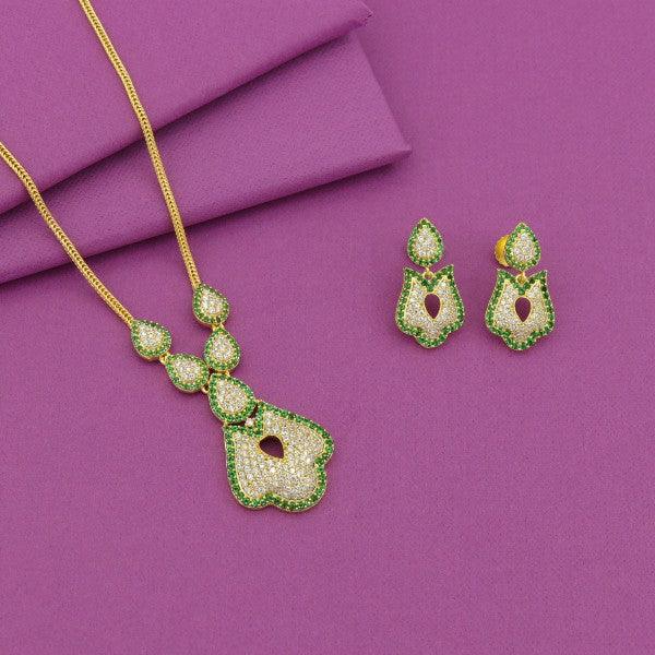 Green and gold necklace with matching earrings set on a purple background.