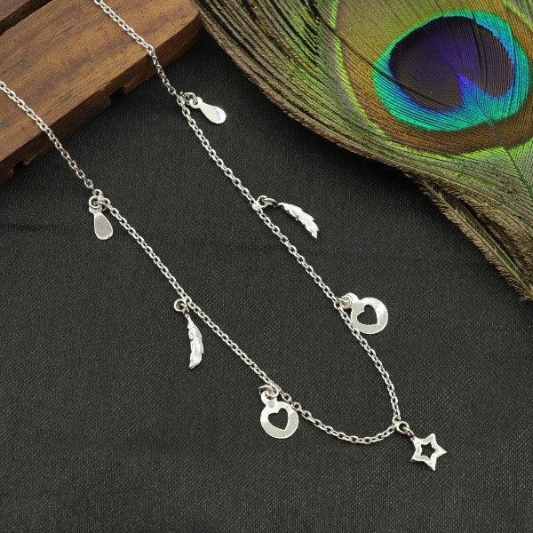 925 Silver Urja Women Necklace NK-128 with heart and star charms on display against a peacock feather.