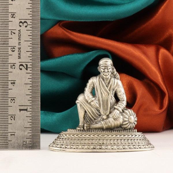 925 silver Sai Baba idol weighing 48g and measuring 5.5cms in length, shown with a ruler for scale.