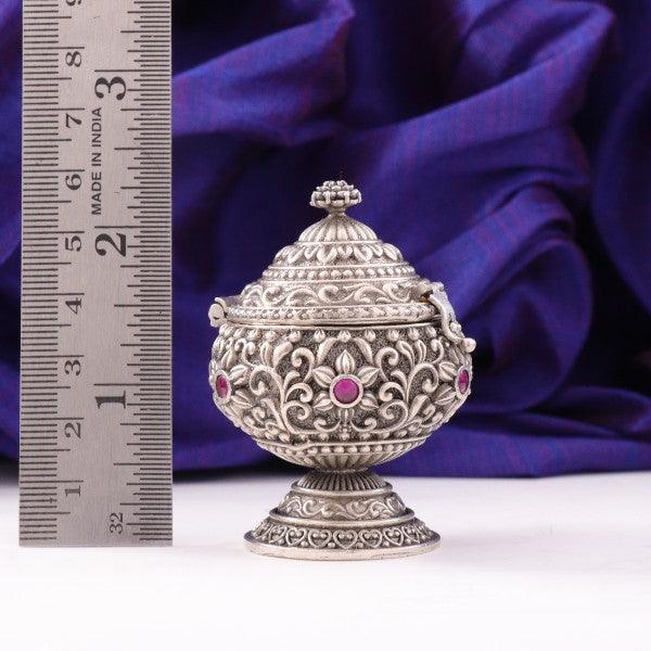 925 silver 3D kumkuma box weighing 74g with intricate design and red gemstones, measuring 6cms in length.