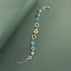 925 silver flower women bracelet LBR-347 showcasing intricate design with blue and yellow ornaments on green background.